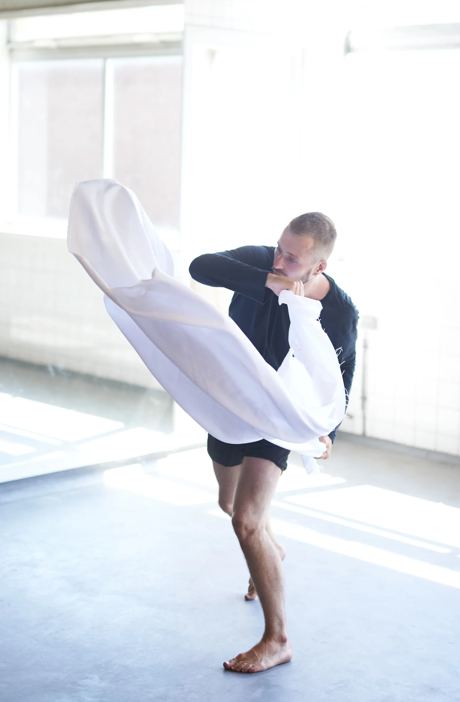 Sam moving with a flowing piece of white fabric