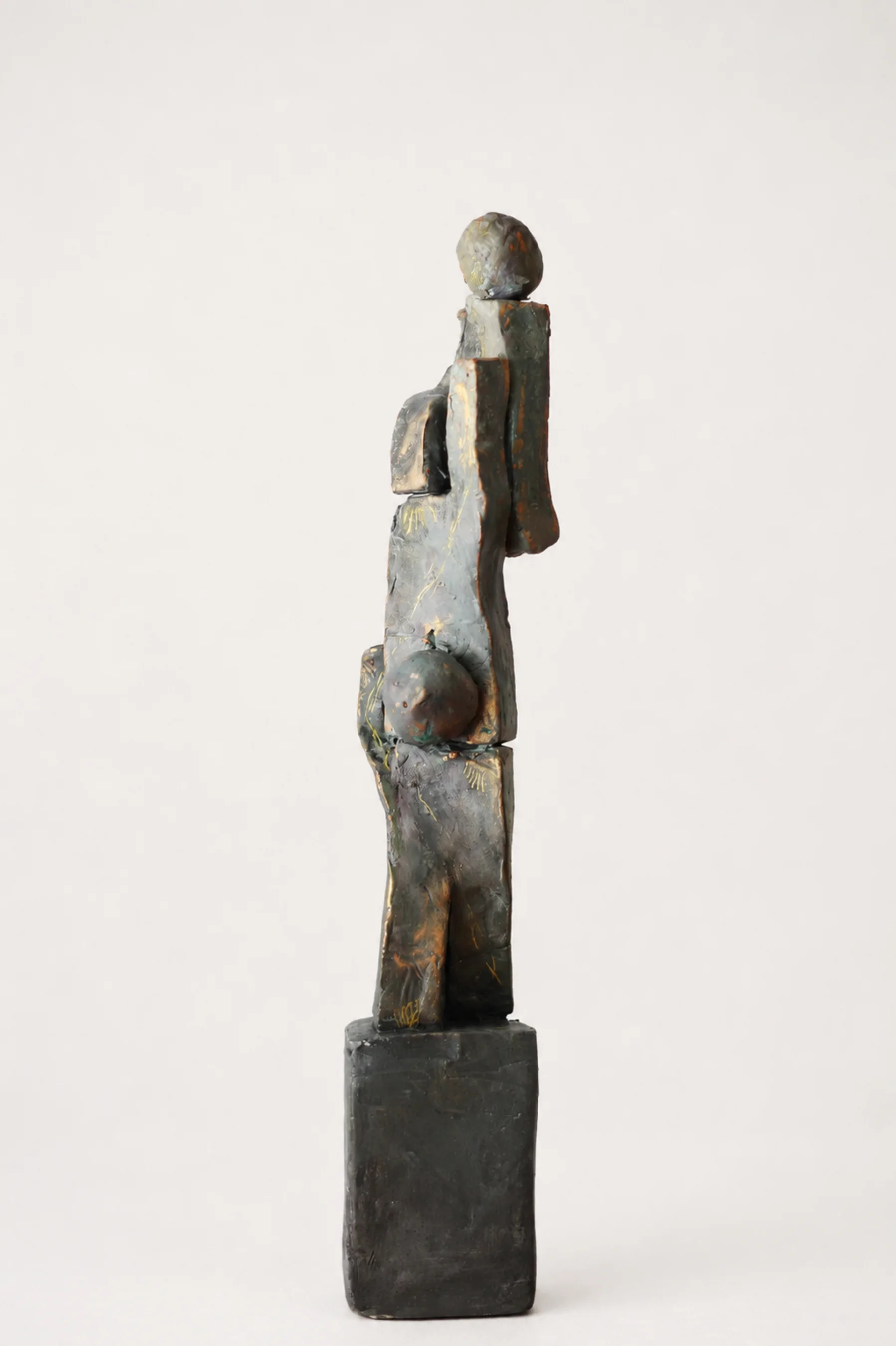 A tall stack of Sam's handmade figurines balancing together